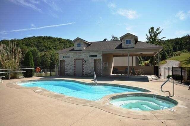 view of swimming pool featuring a community hot tub and a patio area