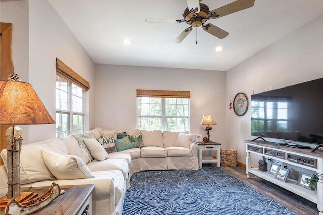 living room with ceiling fan and dark wood-type flooring