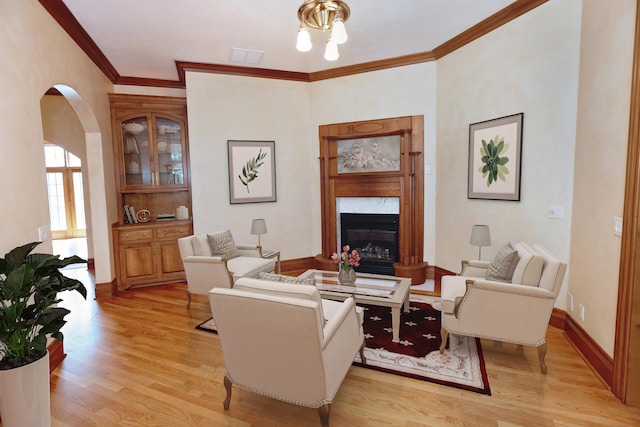 living room with ornamental molding and light wood-type flooring