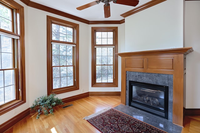 interior space featuring wood-type flooring, crown molding, and ceiling fan