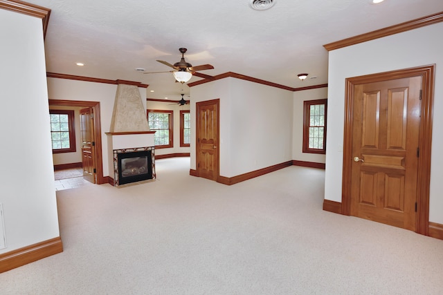 carpeted living room with a fireplace, ornamental molding, a textured ceiling, and ceiling fan