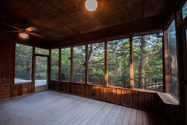 unfurnished sunroom featuring ceiling fan and wooden ceiling