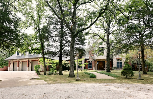 view of front of property featuring a garage and a front lawn