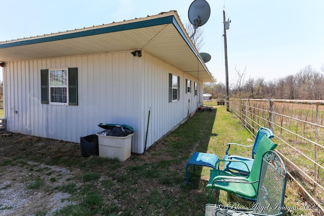 view of side of property with a lawn