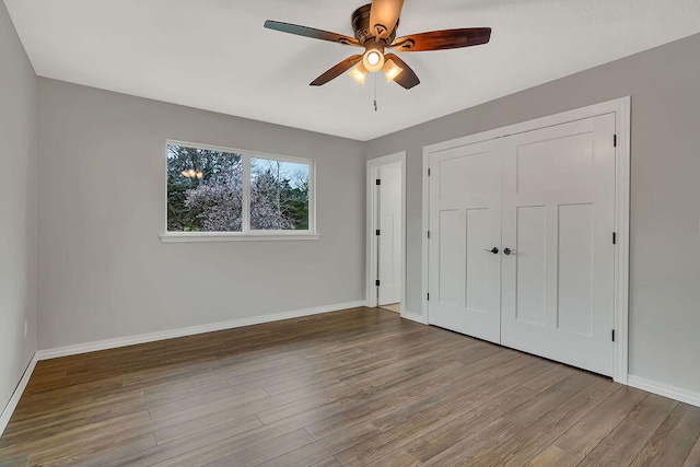 unfurnished bedroom featuring light wood-type flooring, ceiling fan, and a closet