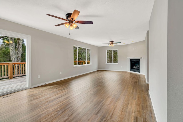 unfurnished living room with light wood-type flooring and ceiling fan