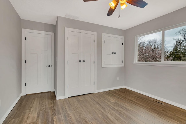 unfurnished bedroom with light wood-type flooring and ceiling fan