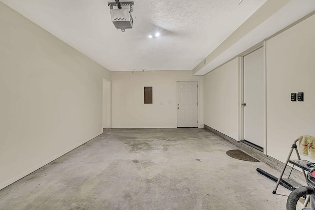 garage with a garage door opener and electric panel