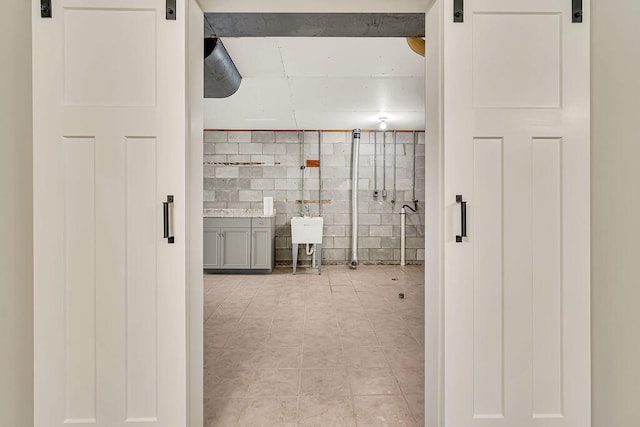 interior space featuring sink and tile walls