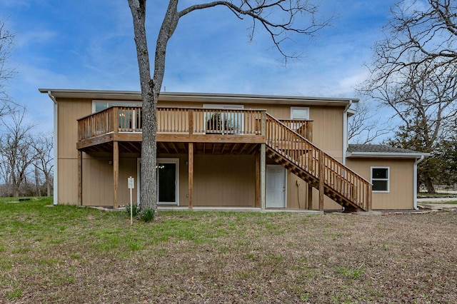 rear view of property featuring a deck and a lawn