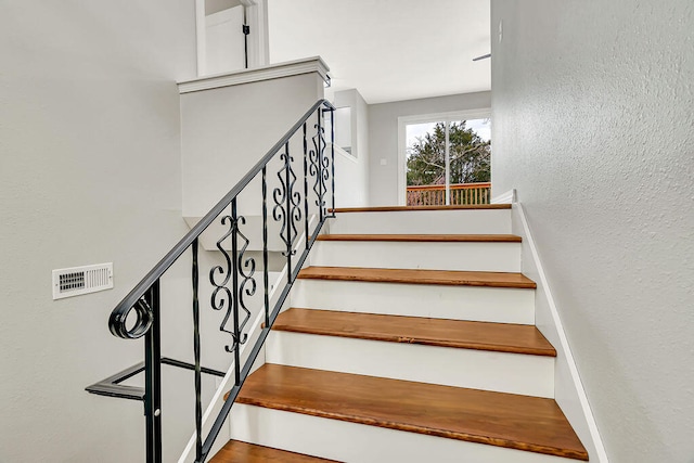 staircase with hardwood / wood-style flooring