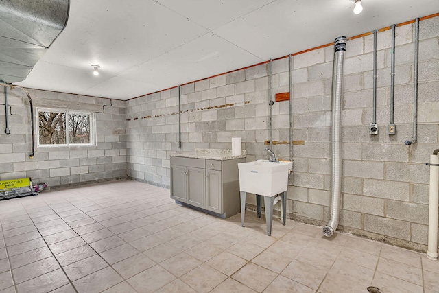 basement featuring light tile patterned flooring