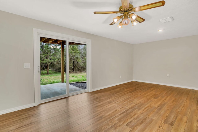 spare room featuring light hardwood / wood-style flooring and ceiling fan