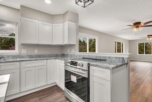 kitchen featuring ceiling fan, dark wood-type flooring, white cabinetry, light stone countertops, and stainless steel electric range oven