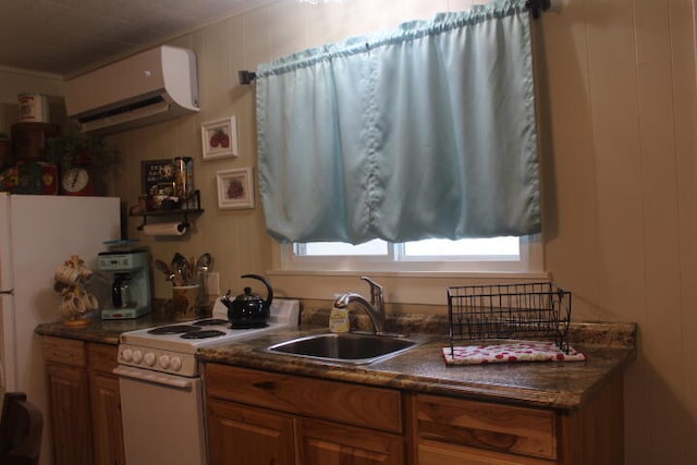 kitchen with sink, white appliances, and a wall mounted AC