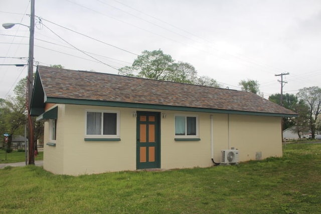 exterior space featuring a yard and ac unit