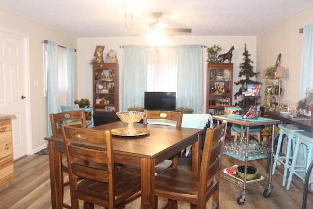 dining room featuring wood-type flooring and ceiling fan