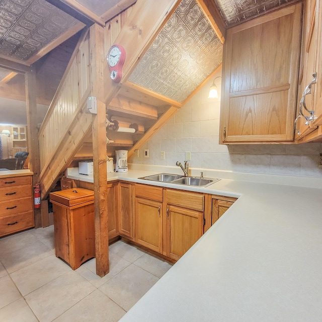 kitchen featuring light countertops, a sink, and an ornate ceiling