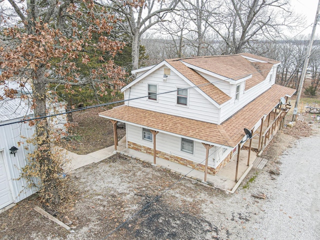 view of property exterior featuring roof with shingles