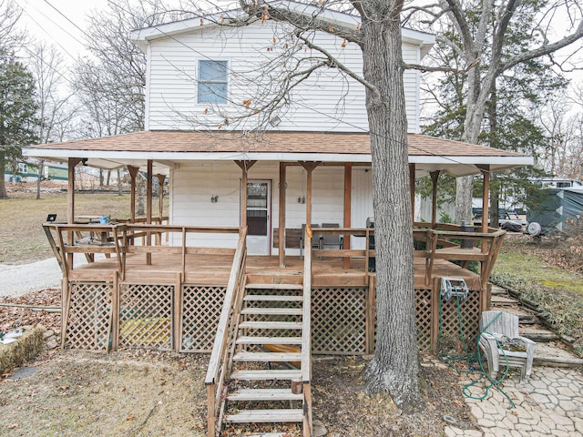 view of front of property featuring a shingled roof and covered porch