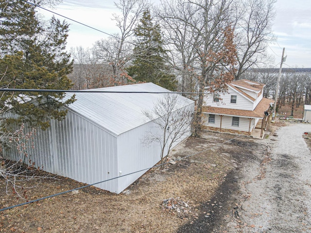 view of side of property featuring an outdoor structure and a pole building