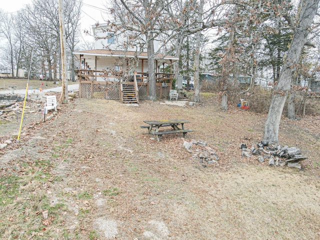 view of yard with a wooden deck and stairs