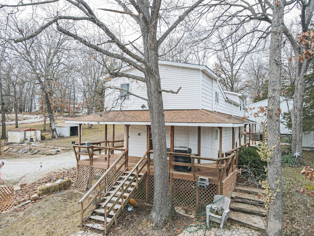 back of house featuring a wooden deck