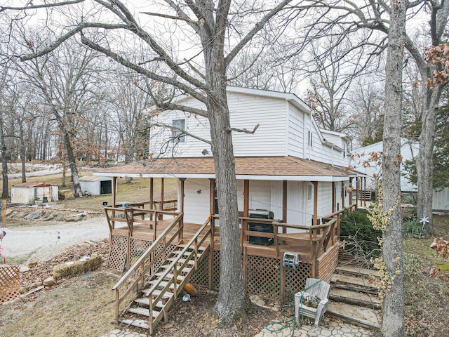 view of front of home with a porch, stairs, and a shingled roof