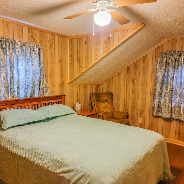 bedroom featuring lofted ceiling, ceiling fan, wood walls, and a textured ceiling