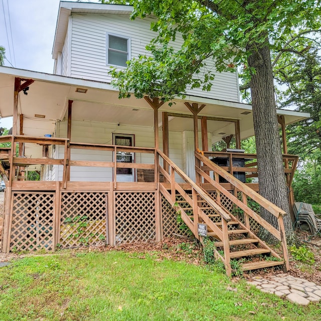 rear view of house featuring a porch and stairs