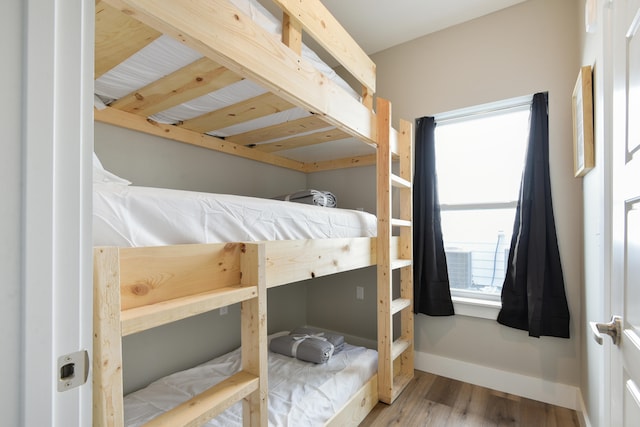 bedroom with hardwood / wood-style flooring