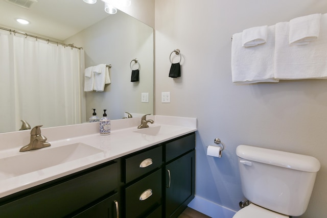 bathroom with vanity and toilet