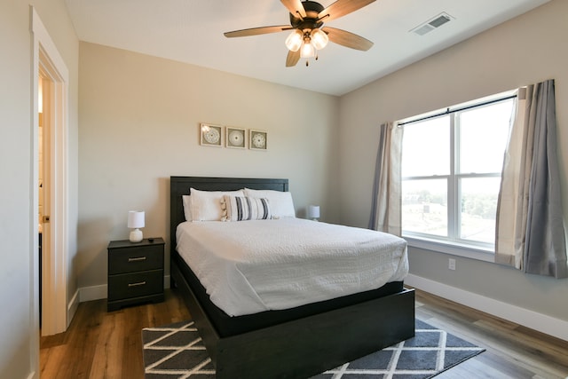 bedroom with dark wood-type flooring and ceiling fan