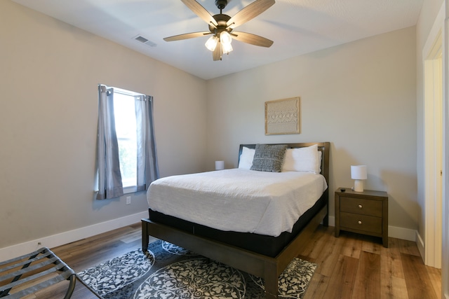 bedroom with hardwood / wood-style floors and ceiling fan