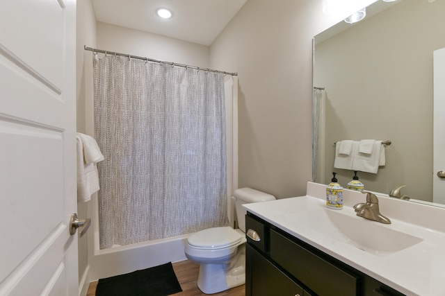 bathroom featuring wood-type flooring, vanity, and toilet