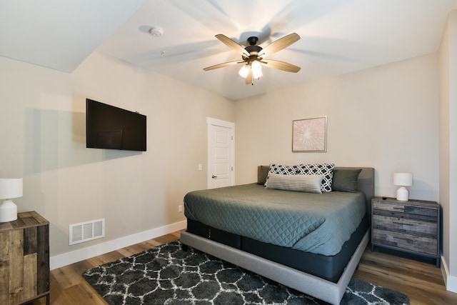 bedroom with ceiling fan and dark wood-type flooring