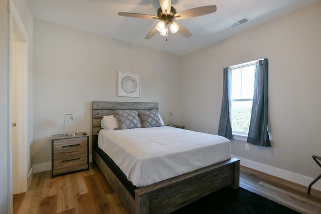 bedroom with wood-type flooring and ceiling fan