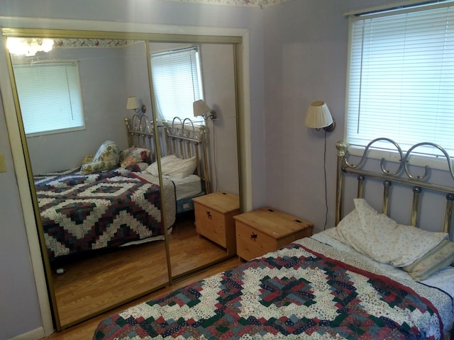 bedroom with hardwood / wood-style floors and a closet