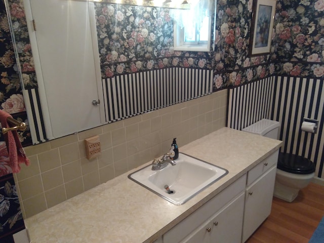 bathroom featuring hardwood / wood-style flooring, vanity, and toilet