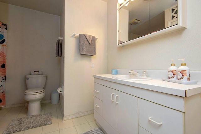 bathroom with vanity, toilet, and tile patterned floors