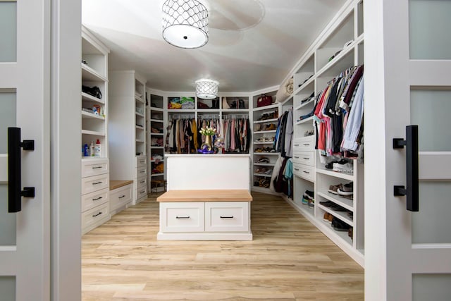 spacious closet with light hardwood / wood-style floors