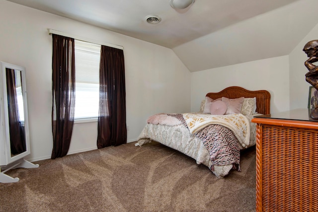 carpeted bedroom with lofted ceiling