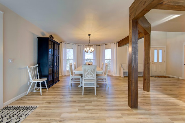 dining space featuring a notable chandelier and light hardwood / wood-style flooring