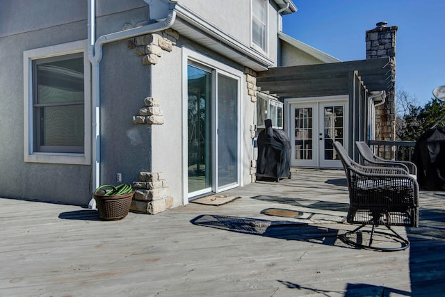 wooden terrace featuring area for grilling and french doors