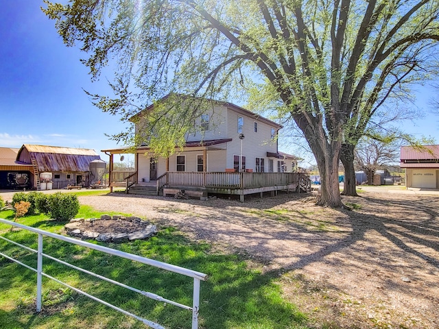 exterior space featuring a garage, a deck, and a lawn