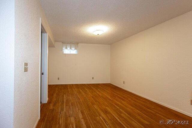 4565 State Route Cc, West Plains, MO 65775 - empty room featuring a textured wall, hardwood / wood-style flooring, baseboards, and a textured ceiling
