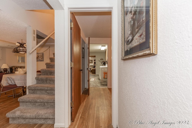 4565 State Route Cc, West Plains, MO 65775 - hall featuring a textured wall, wood finished floors, a textured ceiling, and stairs
