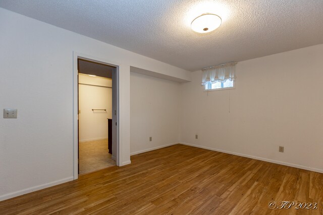 unfurnished bedroom featuring hardwood / wood-style floors and a textured ceiling