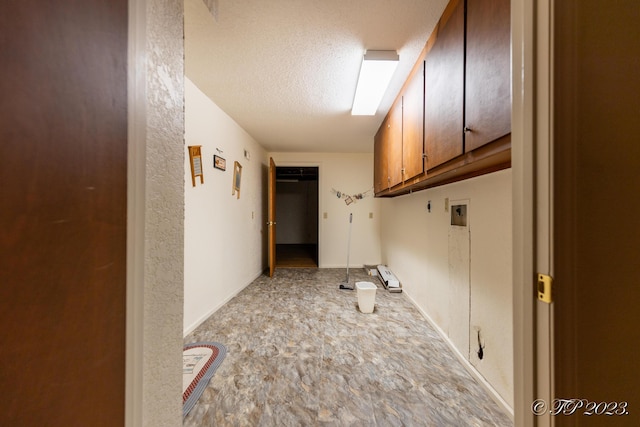 4565 State Route Cc, West Plains, MO 65775 - laundry area with baseboards, cabinet space, and a textured ceiling