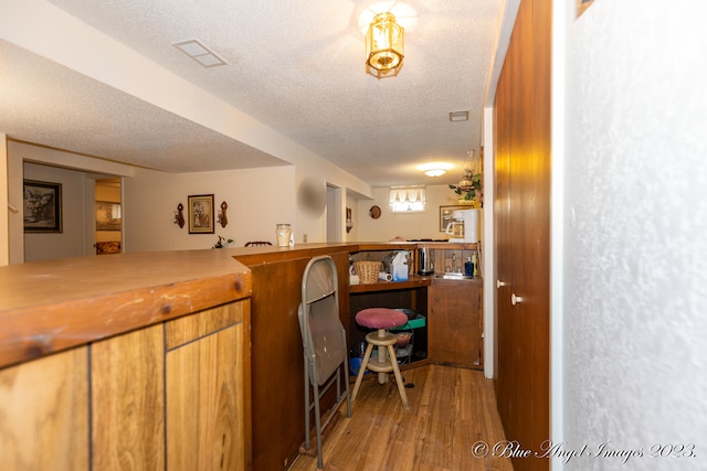 interior space with light hardwood / wood-style flooring and a textured ceiling